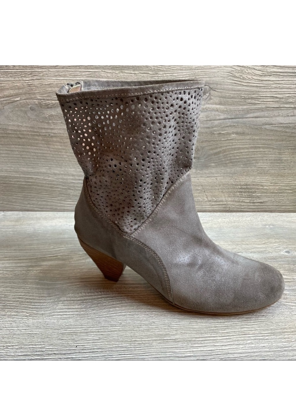 Woman’s grey perforated fine leather shirt ankle boot full heel zipper